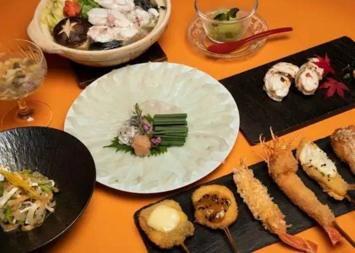 A spread of Japanese dishes at Daikanyama Rokkakutei, a kushikatsu restaurant in Japan.